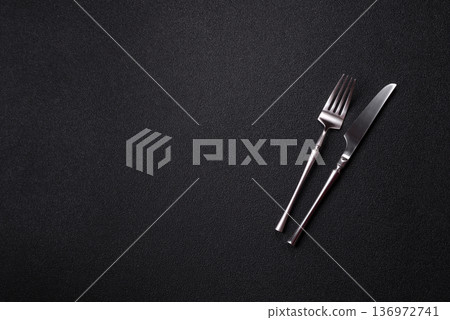 A knife and fork, silver kitchen utensils for the dining table. A knife and fork A knife and fork, silver kitchen utensils for the dining table. A knife and fork 136972741