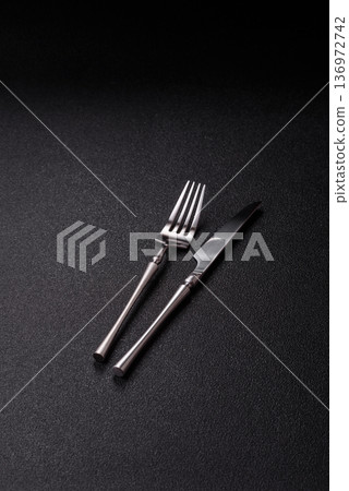 A knife and fork, silver kitchen utensils for the dining table. A knife and fork A knife and fork, silver kitchen utensils for the dining table. A knife and fork 136972742