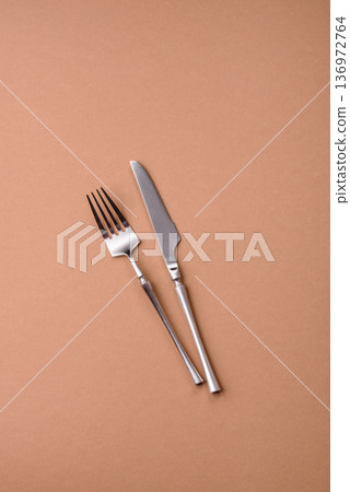 A knife and fork, silver kitchen utensils for the dining table. A knife and fork A knife and fork, silver kitchen utensils for the dining table. A knife and fork 136972764