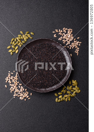 Black sesame seeds in a bowl, an ingredient for oil and healthy eating. Black sesame 136972805