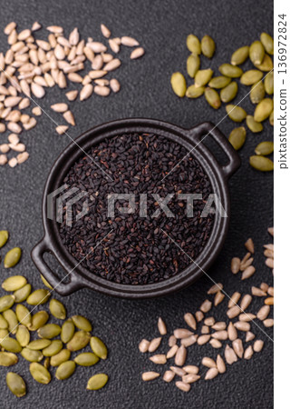 Black sesame seeds in a bowl, an ingredient for oil and healthy eating. Black sesame Black sesame seeds in a bowl, an ingredient for oil and healthy eating. Black sesame 136972824
