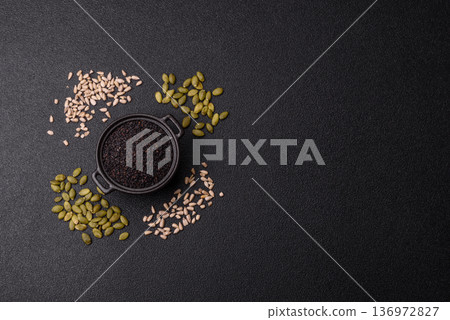 Black sesame seeds in a bowl, an ingredient for oil and healthy eating. Black sesame Black sesame seeds in a bowl, an ingredient for oil and healthy eating. Black sesame 136972827
