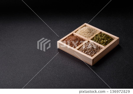Flax, pumpkin, sunflower, and sesame seeds, ingredients for healthy eating Flax, pumpkin, sunflower, and sesame seeds, ingredients for healthy eating 136972829