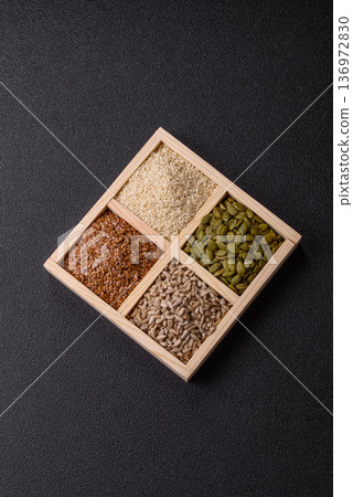 Flax, pumpkin, sunflower, and sesame seeds, ingredients for healthy eating 136972830
