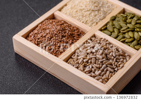 Flax, pumpkin, sunflower, and sesame seeds, ingredients for healthy eating 136972832