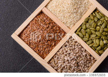 Flax, pumpkin, sunflower, and sesame seeds, ingredients for healthy eating Flax, pumpkin, sunflower, and sesame seeds, ingredients for healthy eating 136972833