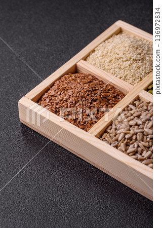 Flax, pumpkin, sunflower, and sesame seeds, ingredients for healthy eating 136972834