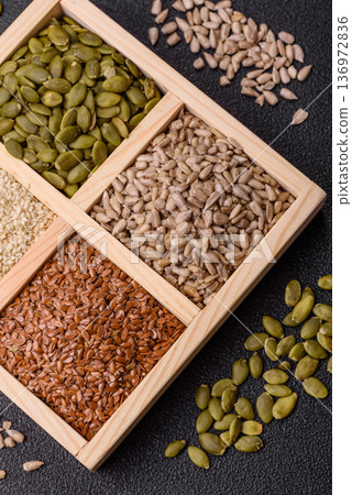 Flax, pumpkin, sunflower, and sesame seeds, ingredients for healthy eating 136972836