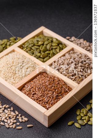 Flax, pumpkin, sunflower, and sesame seeds, ingredients for healthy eating 136972837