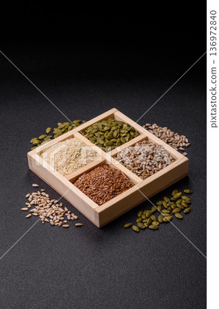Flax, pumpkin, sunflower, and sesame seeds, ingredients for healthy eating Flax, pumpkin, sunflower, and sesame seeds, ingredients for healthy eating 136972840