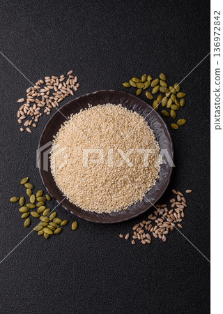 White sesame seeds in a bowl, an ingredient for oil and healthy eating. White sesame 136972842