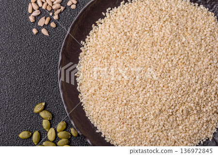 White sesame seeds in a bowl, an ingredient for oil and healthy eating. White sesame 136972845