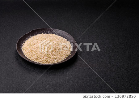 White sesame seeds in a bowl, an ingredient for oil and healthy eating. White sesame 136972850