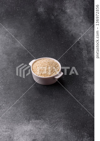 White sesame seeds in a bowl, an ingredient for oil and healthy eating. White sesame 136972856