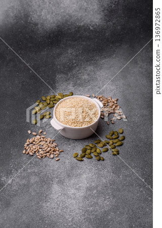 White sesame seeds in a bowl, an ingredient for oil and healthy eating. White sesame 136972865
