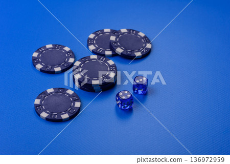 Casino dice and chips on a colored background, poker, gambling with bets. Dice and chips Casino dice and chips on a colored background, poker, gambling with bets. Dice and chips 136972959