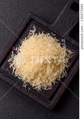 Grated Parmesan cheese as a cooking or baking ingredient. Grated Parmesan cheese Grated Parmesan cheese as a cooking or baking ingredient. Grated Parmesan cheese 136973080