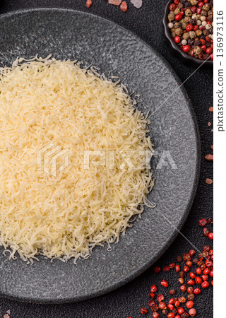 Grated Parmesan cheese as a cooking or baking ingredient. Grated Parmesan cheese Grated Parmesan cheese as a cooking or baking ingredient. Grated Parmesan cheese 136973116