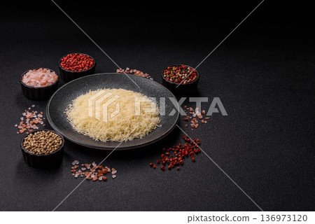 Grated Parmesan cheese as a cooking or baking ingredient. Grated Parmesan cheese 136973120