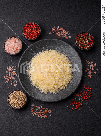 Grated Parmesan cheese as a cooking or baking ingredient. Grated Parmesan cheese Grated Parmesan cheese as a cooking or baking ingredient. Grated Parmesan cheese 136973124