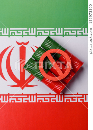 Barrels of oil, gas, or chemicals bearing the Iranian flag and a ban sign. Barrels of Iranian oil 136973300