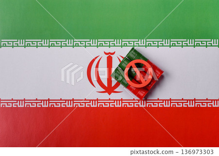 Barrels of oil, gas, or chemicals bearing the Iranian flag and a ban sign. Barrels of Iranian oil 136973303