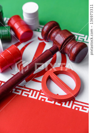 Barrels of oil, gas, or chemicals bearing the Iranian flag and a ban sign. Barrels of Iranian oil 136973311