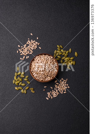 Shelled sunflower seed kernels, salted, roasted, or raw, are a healthy ingredient. Sunflower seeds 136973376