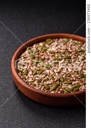 Shelled sunflower, sesame, pumpkin, and flaxseed kernels as ingredients for healthy food 136973408