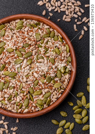 Shelled sunflower, sesame, pumpkin, and flaxseed kernels as ingredients for healthy food Shelled sunflower, sesame, pumpkin, and flaxseed kernels as ingredients for healthy food 136973410