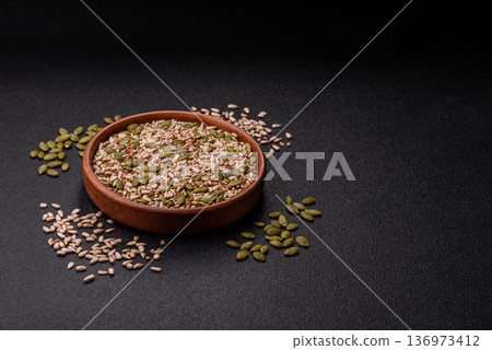 Shelled sunflower, sesame, pumpkin, and flaxseed kernels as ingredients for healthy food Shelled sunflower, sesame, pumpkin, and flaxseed kernels as ingredients for healthy food 136973412