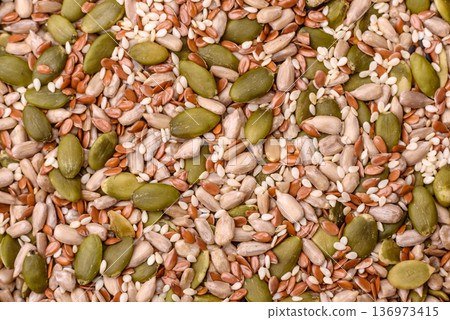 Shelled sunflower, sesame, pumpkin, and flaxseed kernels as ingredients for healthy food Shelled sunflower, sesame, pumpkin, and flaxseed kernels as ingredients for healthy food 136973415