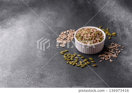 Shelled sunflower, sesame, pumpkin, and flaxseed kernels as ingredients for healthy food Shelled sunflower, sesame, pumpkin, and flaxseed kernels as ingredients for healthy food 136973416