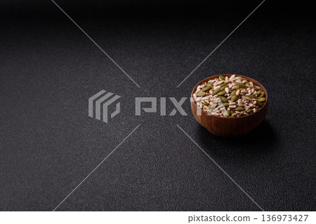 Shelled sunflower, sesame, pumpkin, and flaxseed kernels as ingredients for healthy food 136973427