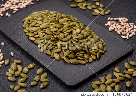 Shelled pumpkin seed kernels, salted, roasted, or raw, are a healthy ingredient. Pumpkin seeds 136973624