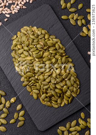 Shelled pumpkin seed kernels, salted, roasted, or raw, are a healthy ingredient. Pumpkin seeds 136973625