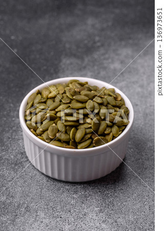 Shelled pumpkin seed kernels, salted, roasted, or raw, are a healthy ingredient. Pumpkin seeds 136973651