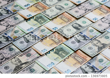 Euro and dollar banknotes, exchange, sales, economic tariffs and taxes. Euros and dollars Euro and dollar banknotes, exchange, sales, economic tariffs and taxes. Euros and dollars 136973805