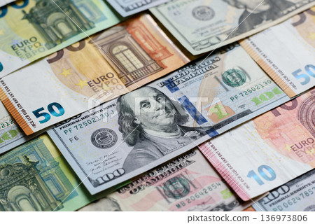 Euro and dollar banknotes, exchange, sales, economic tariffs and taxes. Euros and dollars Euro and dollar banknotes, exchange, sales, economic tariffs and taxes. Euros and dollars 136973806