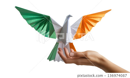 Delicate origami dove folded from the irish flag green, white, orange gently held in a hand, symbolizing peace and unity for ireland 136974087