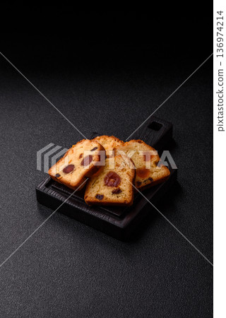 Fruit cake, a dessert with cherries, plums, and raisins for a festive Christmas table. Fruit cake Fruit cake, a dessert with cherries, plums, and raisins for a festive Christmas table. Fruit cake 136974214