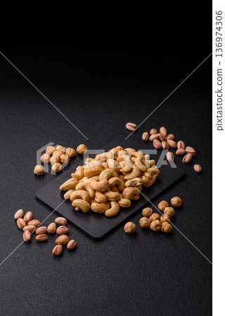 Roasted or raw cashew make a savory snack for a healthy, filling meal. Cashew nuts Roasted or raw cashew make a savory snack for a healthy, filling meal. Cashew nuts 136974306