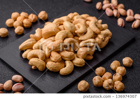 Roasted or raw cashew make a savory snack for a healthy, filling meal. Cashew nuts Roasted or raw cashew make a savory snack for a healthy, filling meal. Cashew nuts 136974307