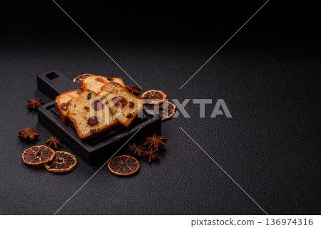Fruit cake, a dessert with cherries, plums, and raisins for a festive Christmas table. Fruit cake Fruit cake, a dessert with cherries, plums, and raisins for a festive Christmas table. Fruit cake 136974316