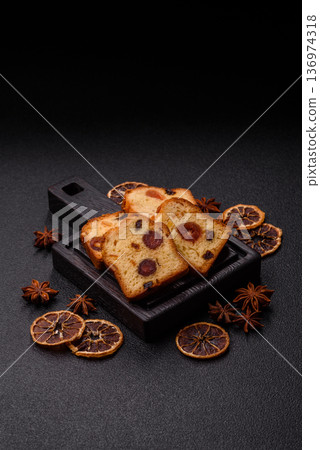 Fruit cake, a dessert with cherries, plums, and raisins for a festive Christmas table. Fruit cake Fruit cake, a dessert with cherries, plums, and raisins for a festive Christmas table. Fruit cake 136974318