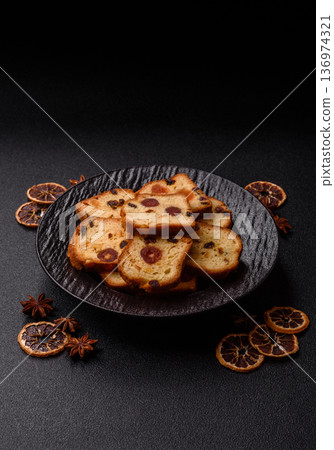 Fruit cake, a dessert with cherries, plums, and raisins for a festive Christmas table. Fruit cake Fruit cake, a dessert with cherries, plums, and raisins for a festive Christmas table. Fruit cake 136974321