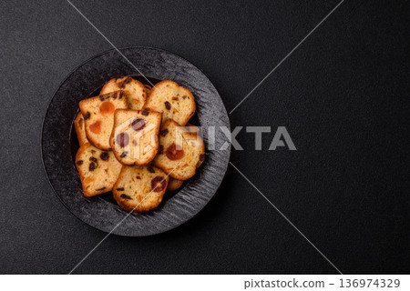 Fruit cake, a dessert with cherries, plums, and raisins for a festive Christmas table. Fruit cake Fruit cake, a dessert with cherries, plums, and raisins for a festive Christmas table. Fruit cake 136974329