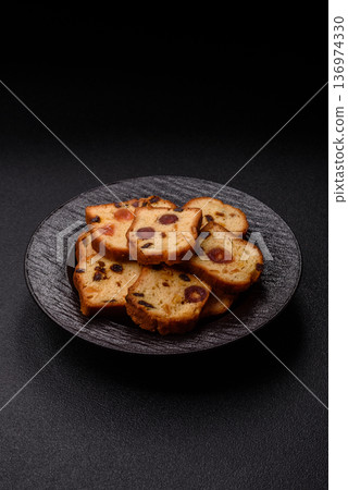 Fruit cake, a dessert with cherries, plums, and raisins for a festive Christmas table. Fruit cake 136974330