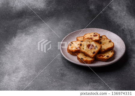 Fruit cake, a dessert with cherries, plums, and raisins for a festive Christmas table. Fruit cake Fruit cake, a dessert with cherries, plums, and raisins for a festive Christmas table. Fruit cake 136974331