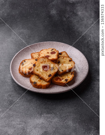 Fruit cake, a dessert with cherries, plums, and raisins for a festive Christmas table. Fruit cake Fruit cake, a dessert with cherries, plums, and raisins for a festive Christmas table. Fruit cake 136974333
